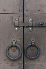 Old rusty door with door-handl and locking bolt