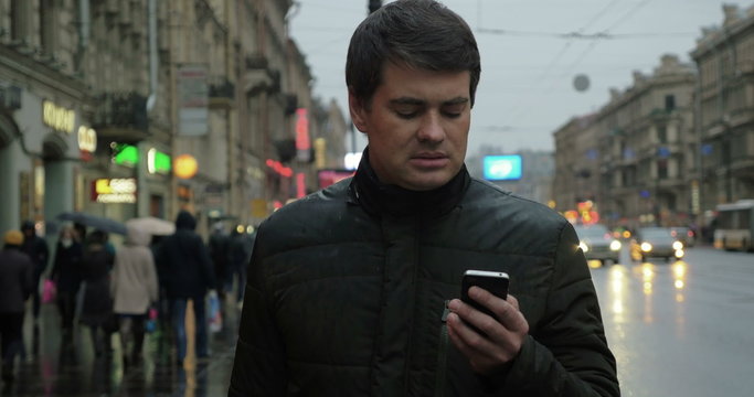 Man using smartphone on the street