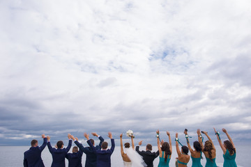 Obraz premium Guests on the wedding celebration are holding their hands up.