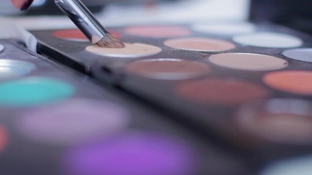 Palette of  eyeshadow. Make-up artist doing make-up.