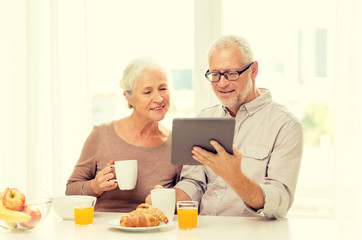 Fototapeta na wymiar happy senior couple with tablet pc at home