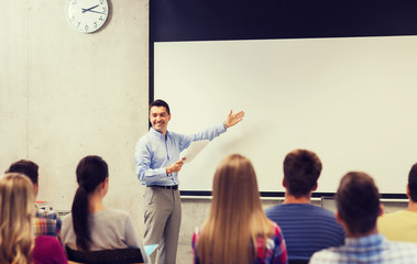 group of students and smiling teacher with notepad