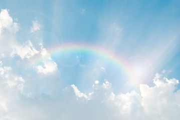 rainbow in the blue sky after the rain with lighting flare