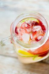 close up of fruit water in glass bottle