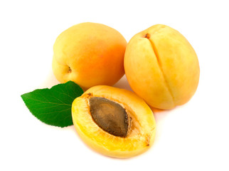 Apricots with leaves on a white background.
