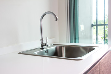 Water tap and sink in a modern kitchen.