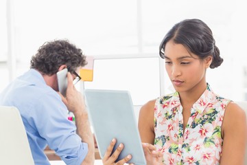 Businesswoman standing and using tablet  