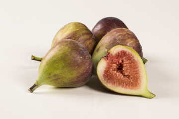 A couple of figs in a pot over a wooden table