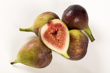 A couple of figs in a pot over a wooden table