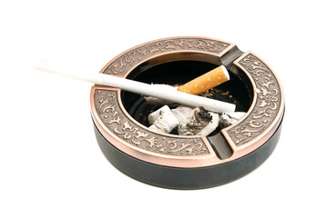 cigarette in the metal ashtray with butts