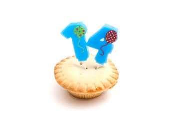 cupcake with fourteen years birthday candle on white