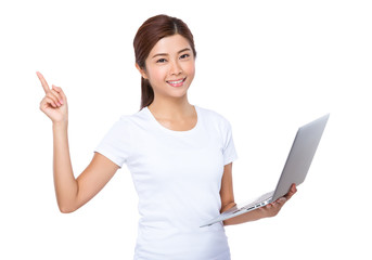 Woman use of the notebook computer and finger point up