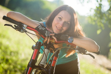 Fototapeta na wymiar Beautiful sport girl with bicycle outdoor