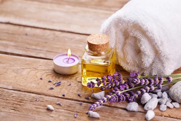 Poster Spa still life with lavender oil, white towel and perfumed candle on natural wood © Floydine