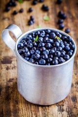 Fresh organic blueberries in a mug