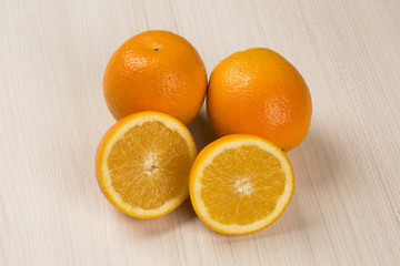 Close up of some oranges in a basket over a wooden surface