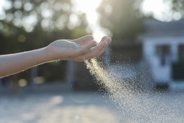 Young man with sand in hand