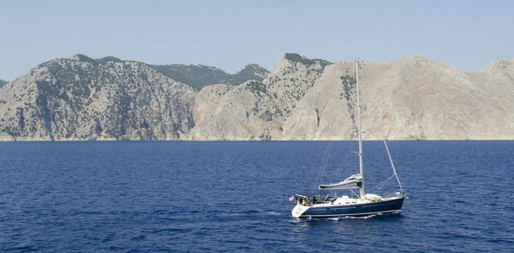 Fototapeta Seascape with yacht, blue sky and mountain