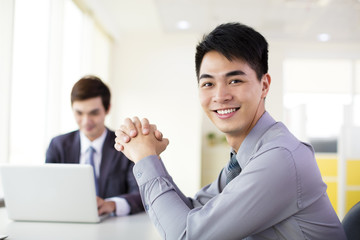 young smiling businessman working in office