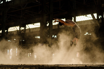 Guy jump backflip in the old hall