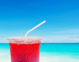 fruit juice on defocused beach background