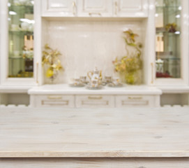 Bleached wooden table on defocused white kitchen furniture background