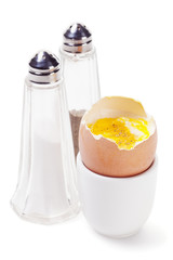 Boiled egg with salt and pepper shakers isolated