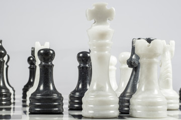 The white king falls under the checkmate of a black pawn. Marble pieces