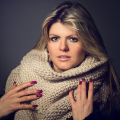 Toned image of young gorgeous woman with scarf in studio