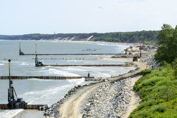 Workers build a breakwater to facilitate the construction of the beach in Ustka, Poland.