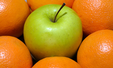 Apple and oranges close up.