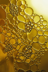 oil floating on yellow background