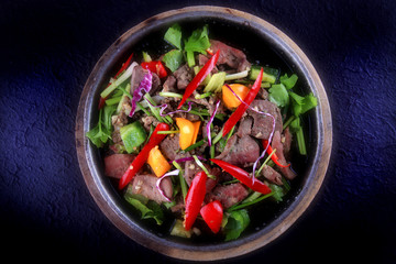 Thai Food - Stir fried Pork liver with goat pepper, sweet pepper, scallion and celery serve on hot plate