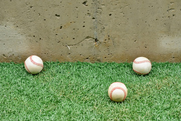 Three baseball ball on grass