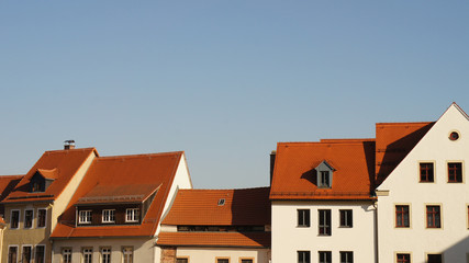 Über den Dächern/Hausdächer einer Altstadt, rote Ziegeldächer, blauer Himmel