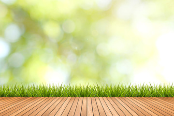 grass with green blurred background and wood floor