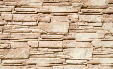 Decorative relief cladding slabs imitating stones on wall
