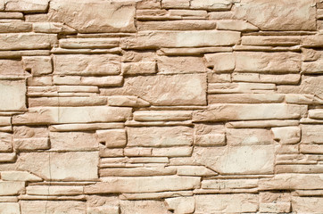 Decorative relief cladding slabs imitating stones on wall