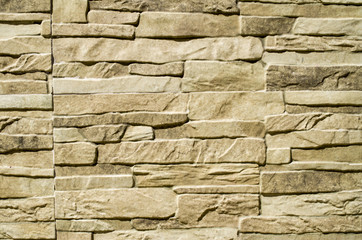 Decorative relief cladding slabs imitating stones on wall