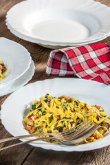 Spaghetti with spinach and bacon.