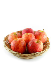 Fresh of apples on a basket isolated on white background