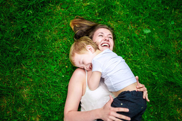 Cute cheerful child with mother play outdoors
