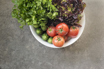 Freshly harvested organic vegetables  on a gray background