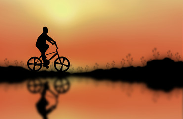 Obraz premium Silhouette of children cycling on the mountain.
