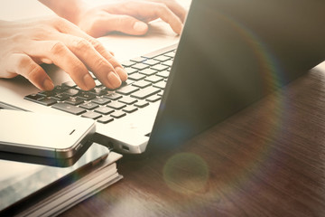 designer hand working with digital tablet and laptop and noteboo