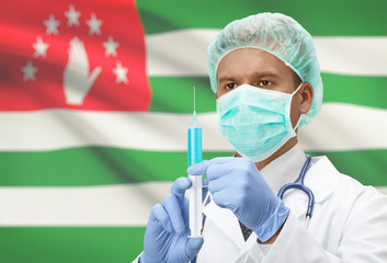 Doctor with syringe in hands and flag on background series - Abkhazia