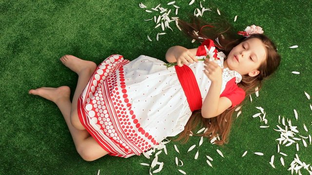 Girl 6 Years Old Lying on the Grass and Separates From the
