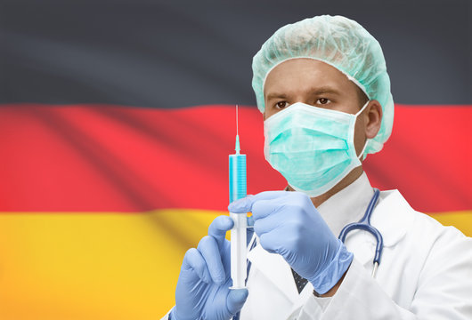 Doctor with syringe in hands and flag on background series - Germany