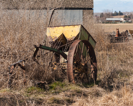 Old yellow rusty farm equipment