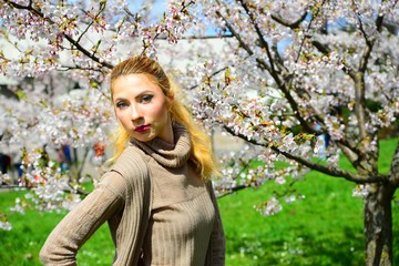 Young girl posing in the sakura garden